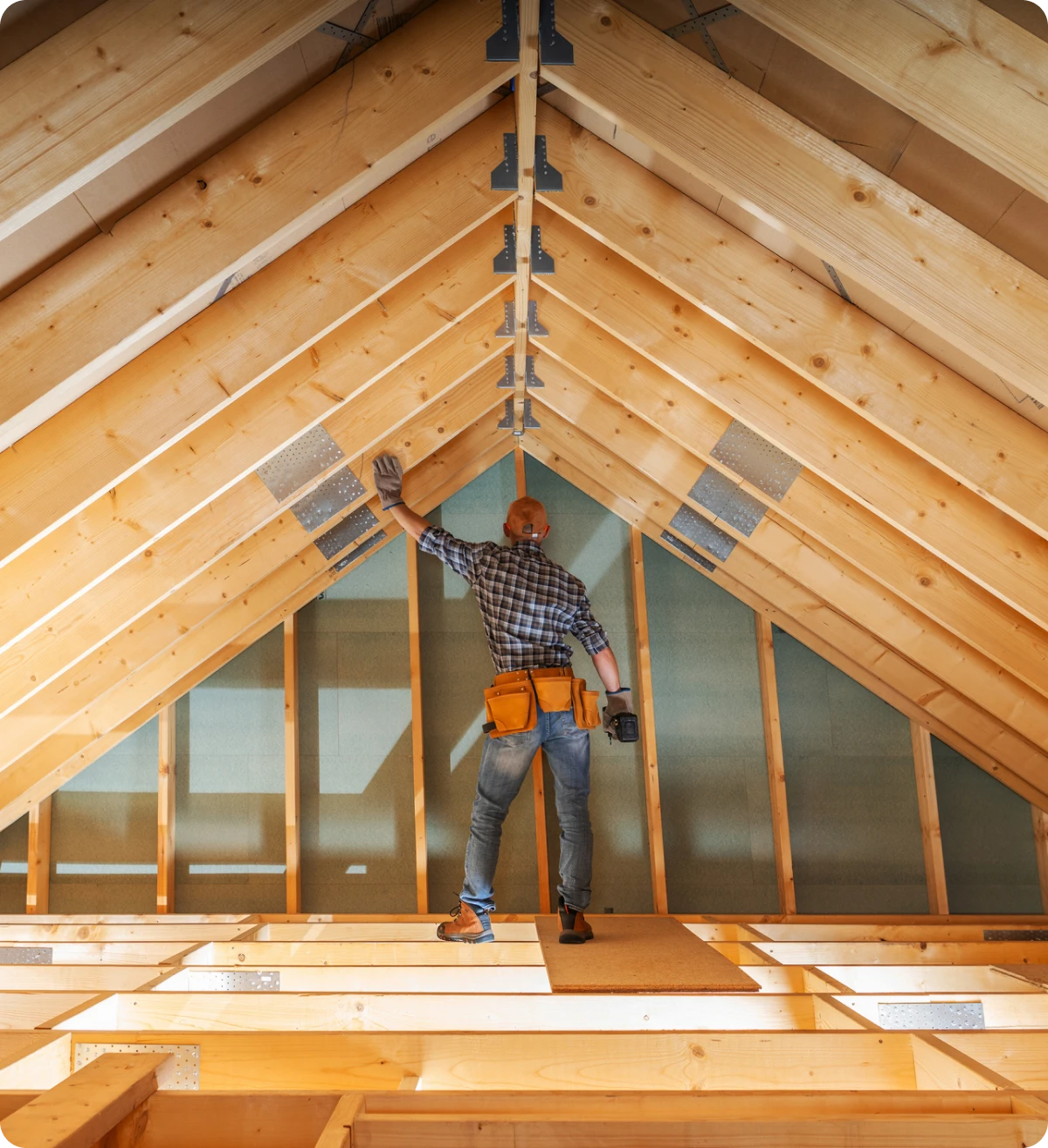 Worker in attic construction area