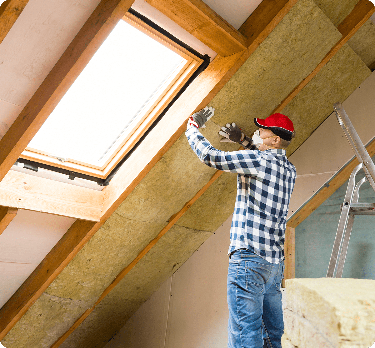Worker insulating attic with mineral wool