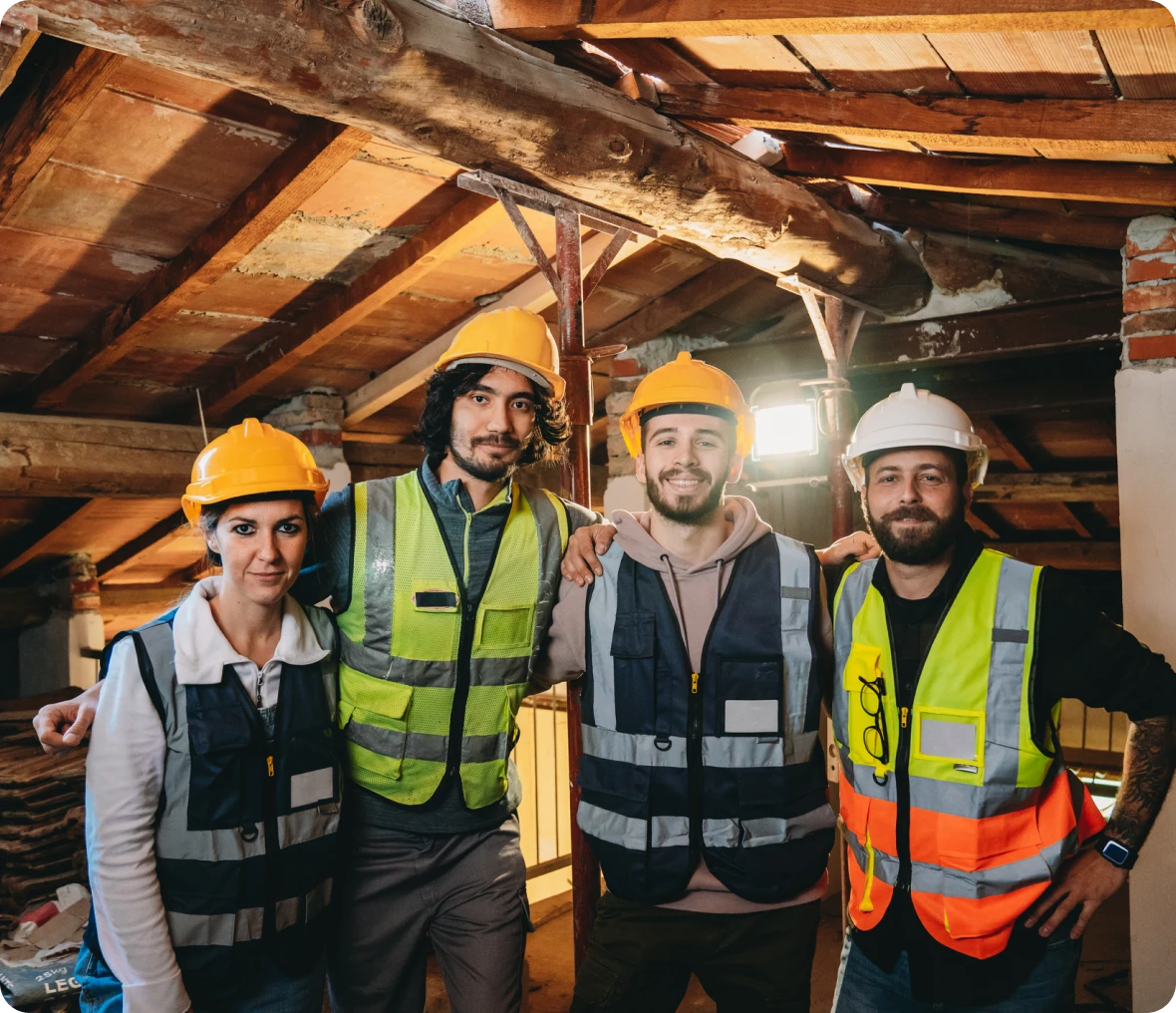 Builders posing in renovated loft space